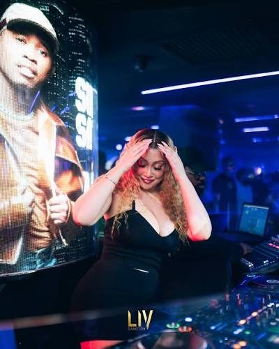 Crowd dancing close together under club lighting at night